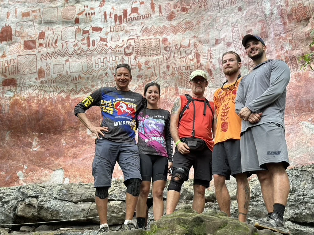 Marcel, Johana, and the Mountain Bike Colombia team at La Lindosa ancient rock art, Colombia